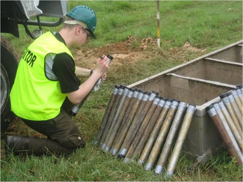 Geotechnical survey in Malaysia by Altus Oil & Gas with a technician inspecting soil core samples in a field.