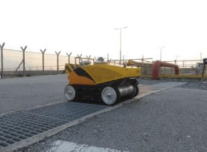 A tracked robot performing inspection and maintenance tasks in an industrial area, showcasing robotic solutions for oil and gas operations.
