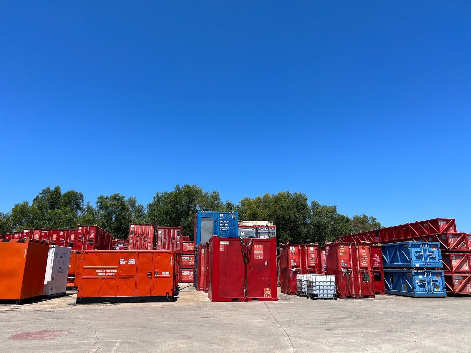Offshore tank containers and chemical storage units in Malaysia oil and gas logistics yard.